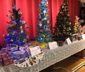 Row of decorated Christmas trees.