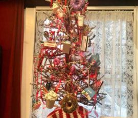 White Christmas tree with red decorations.